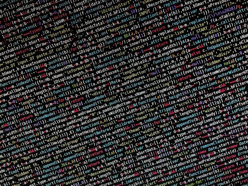 A detailed digital photograph of computer code featuring a mixture of colorful syntax highlighting, including multiple lines of HTML, JavaScript, and CSS scripting, displayed on a dark background. The